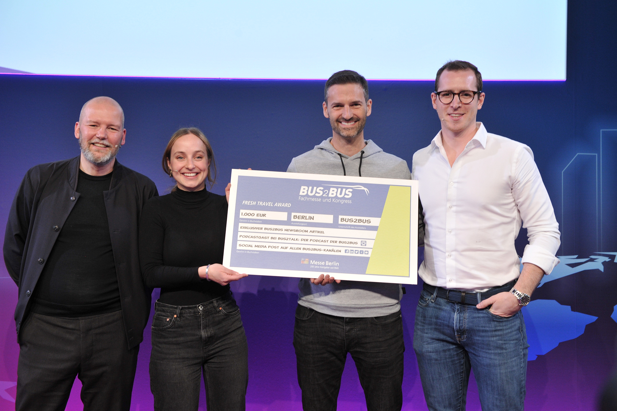 The image shows four people. In the middle is Luca Bortolani, winner of the Fresh Travel Award 2022 and co-founder and CEO of Twiliner. 